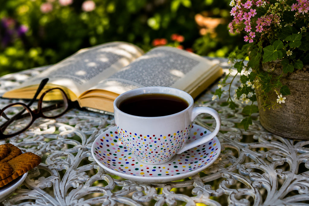 Hand painted ceramic cup with saucer. Colourful Polka Dots.