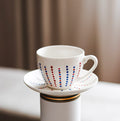 Hand painted ceramic cup with saucer. Blue and red. Polka Dots.