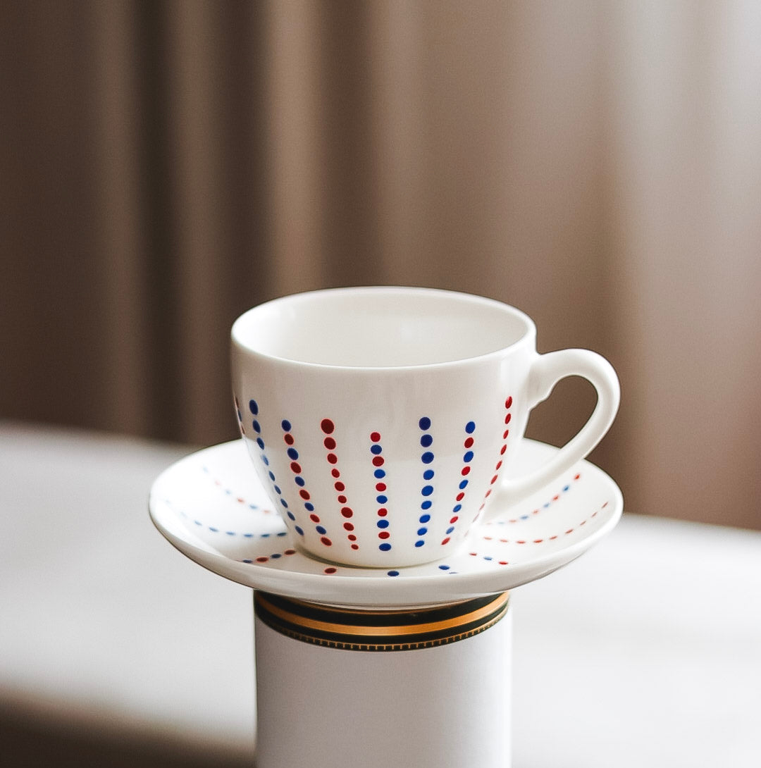 Hand painted ceramic cup with saucer. Blue and red. Polka Dots.