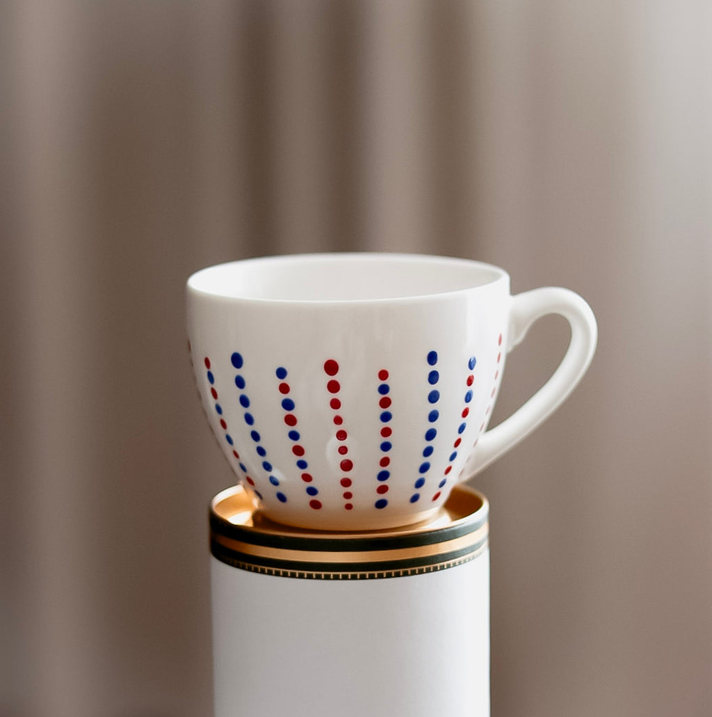 Hand painted ceramic cup with saucer. Blue and red. Polka Dots.