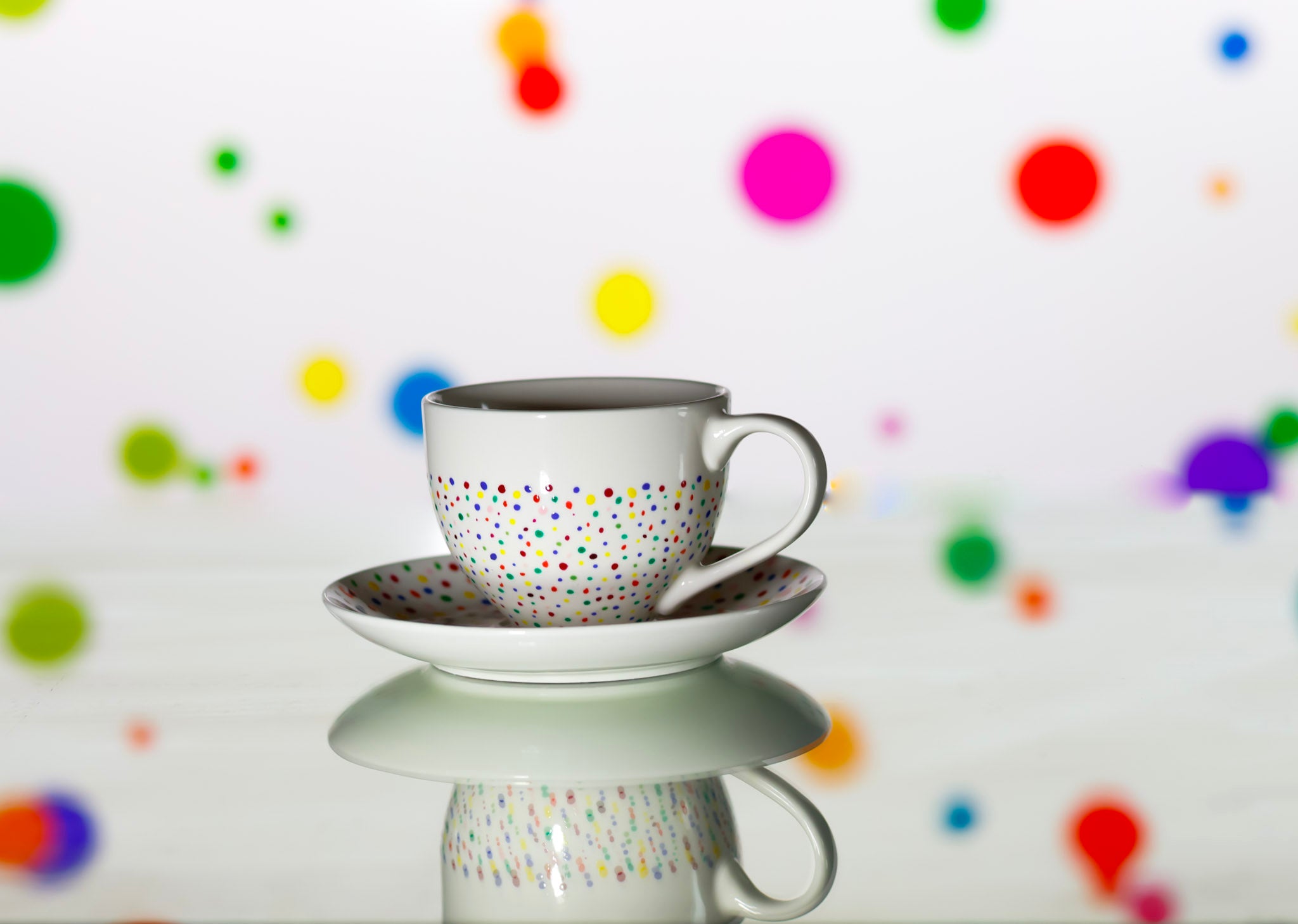 Hand painted ceramic cup with saucer. Colourful Polka Dots.