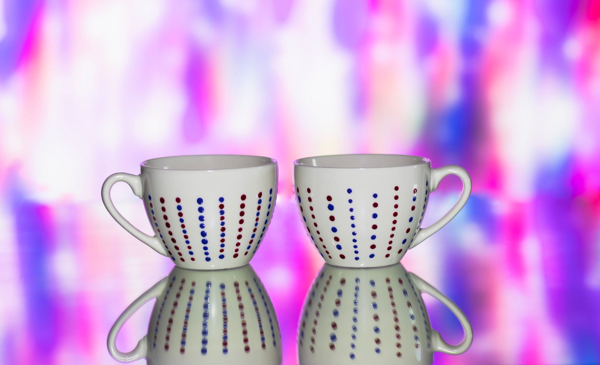 Hand painted ceramic cup with saucer. Blue and red. Polka Dots.