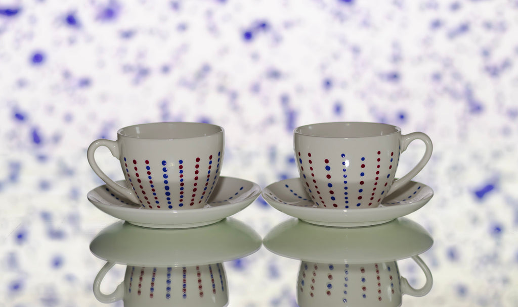 Hand painted ceramic cup with saucer. Blue and red. Polka Dots.